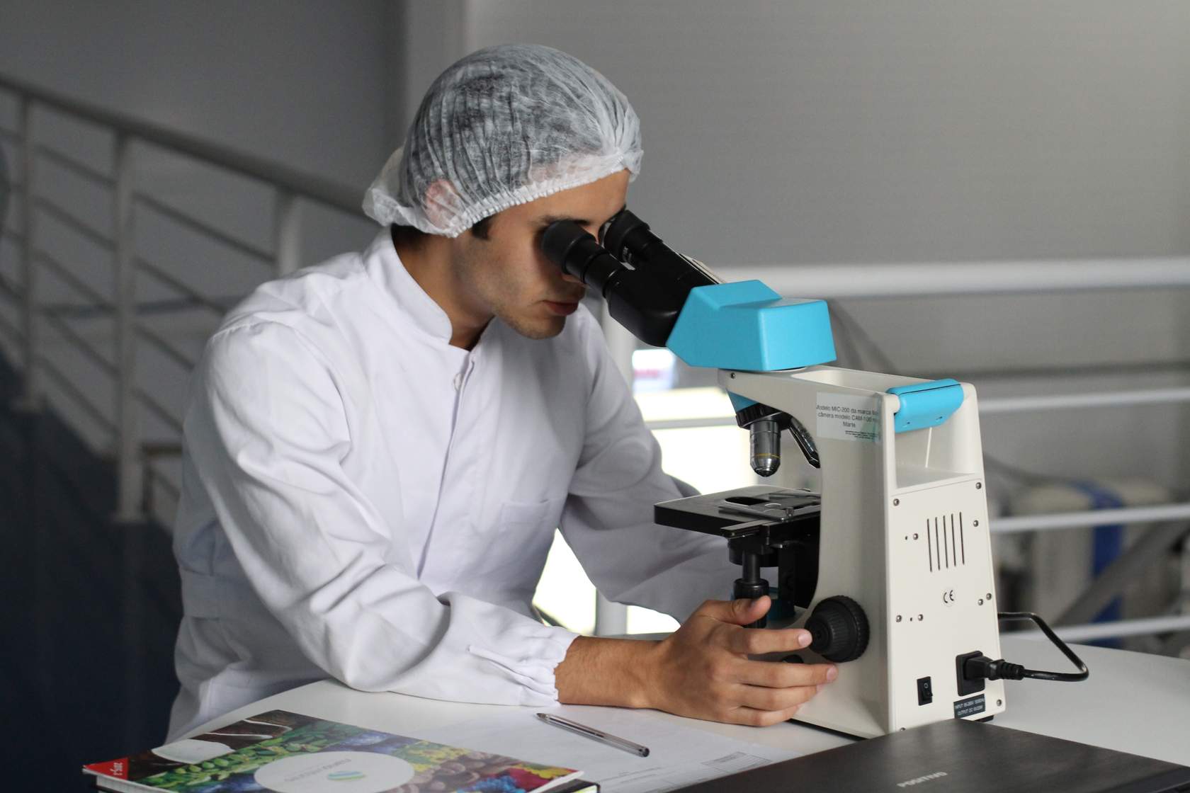 A man using a microscope in a laboratory.
