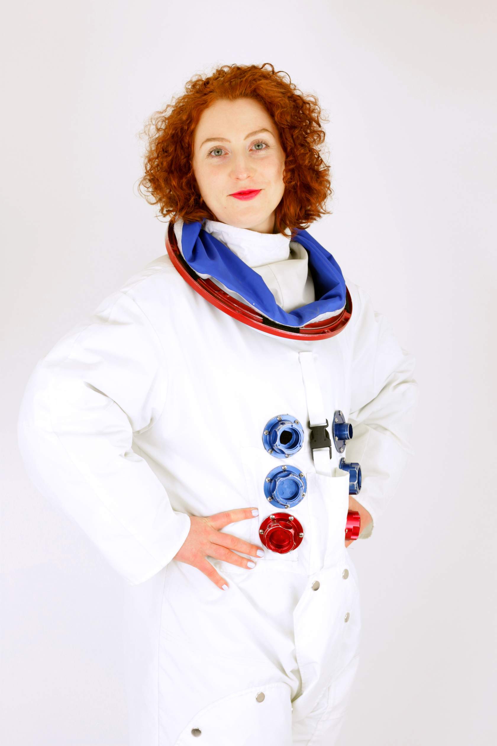 A woman posing for a photo in an astronaut suit.