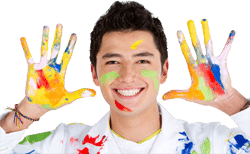 A young man with paint on his hands.