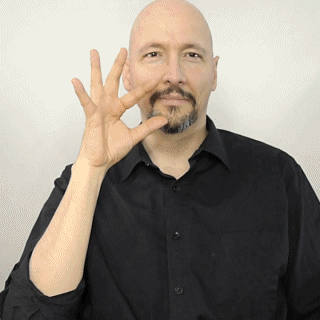 A man making the ok sign with his hands using American Sign Language (ASL).