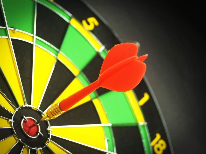 Precision - A dart hitting the bullseye of a dartboard with accuracy.